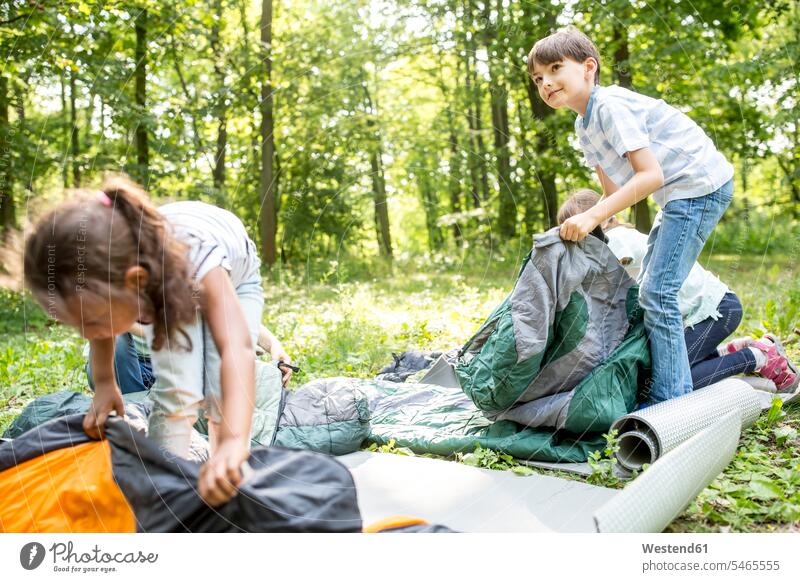 School children unpacking their sleeping bags to camp in the forest learn colour colours explore exploring Adventures adventurous Getaway Tour Tours Trip Trips