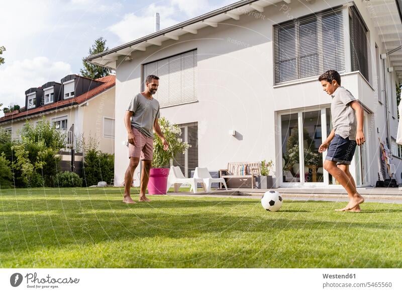 Father and son playing football in garden T- Shirt t-shirts tee-shirt balls footballs soccer balls relax relaxing smile summer time summertime summery delight