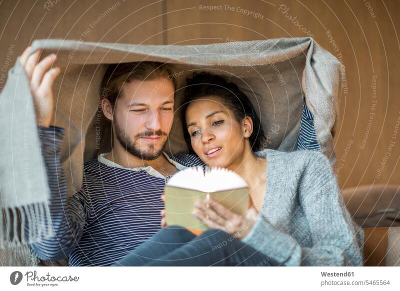 Portrait of young couple relaxing together at home twosomes partnership couples portrait portraits people persons human being humans human beings cozy sociable