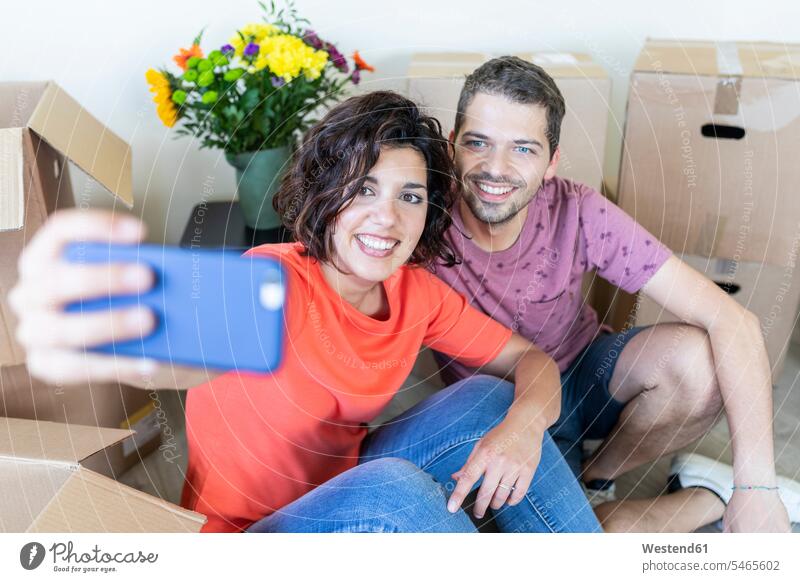 Happy couple taking a selfie in new home human human being human beings humans person persons caucasian appearance caucasian ethnicity european 2 2 people