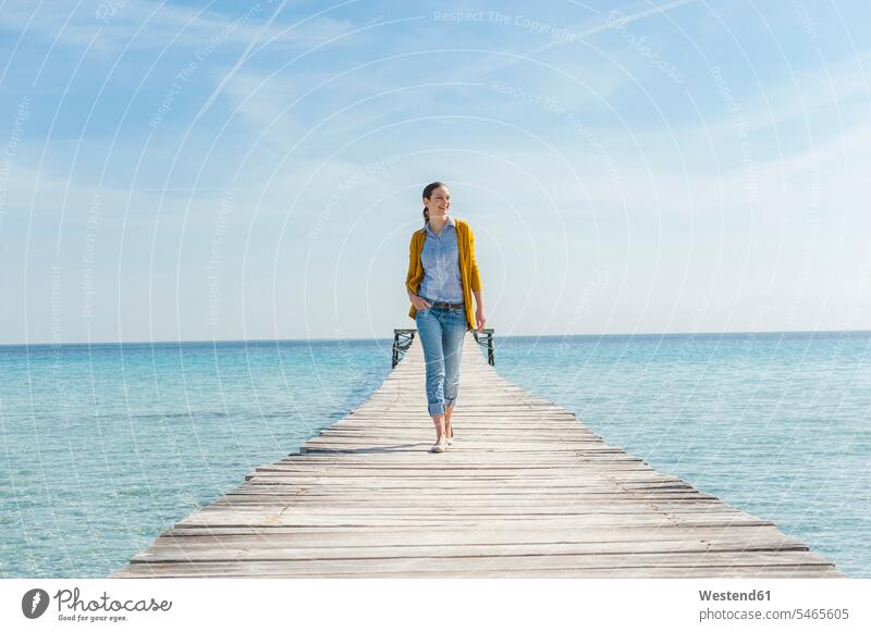 Happy woman walking on jetty, Mallorca, Spain go going smile delight enjoyment Pleasant pleasure happy free time leisure time Lifestyle holiday holidays