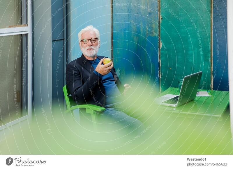 Portrait of senior man sitting outdoors with laptop having a break human human being human beings humans person persons caucasian appearance caucasian ethnicity