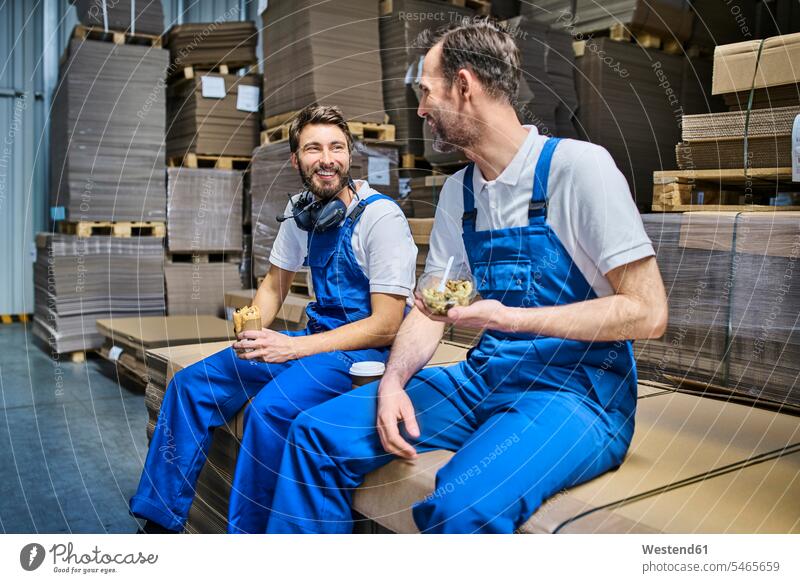 Two happy workers having lunch break in factory colleague Occupation Work job jobs profession professional occupation blue collar blue collar worker