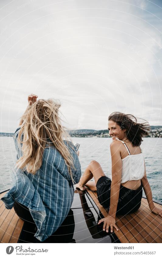 Happy female friends on a boat trip on a lake mate Nautical Vessel nautical vessels water vehicle water vehicles watercraft boats motor boat motor boats