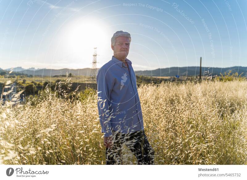 Portrait of senior man standing on a field at sunset human human being human beings humans person persons caucasian appearance caucasian ethnicity european 1