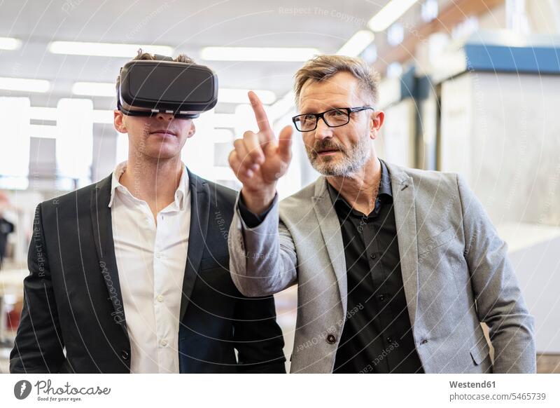Two businessmen with VR glasses in factory colleagues Businessman Business man Businessmen Business men virtual reality factories specs Eye Glasses spectacles