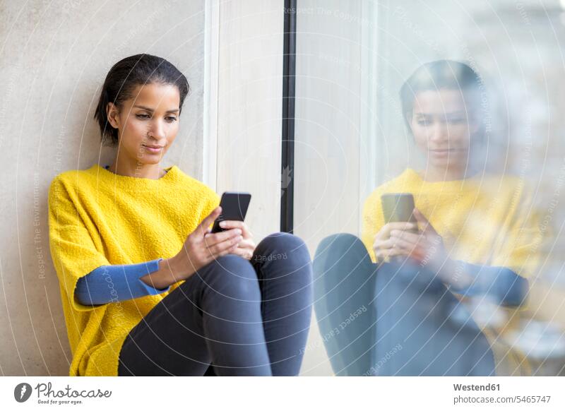 Portrait of young woman using cell phone use portrait portraits females women Smartphone iPhone Smartphones Adults grown-ups grownups adult people persons