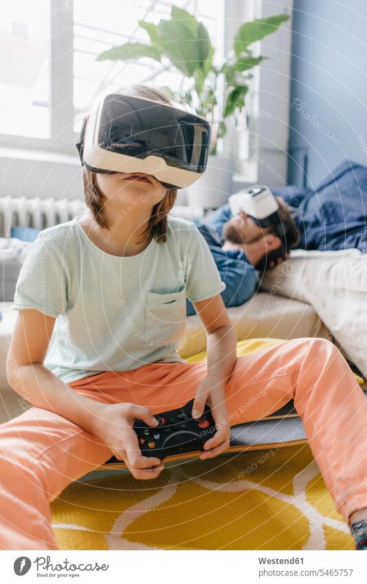 Boy and father wearing VR glasses playing video game at home son sons manchild manchildren video games virtual reality pa fathers daddy dads papa boy boys males