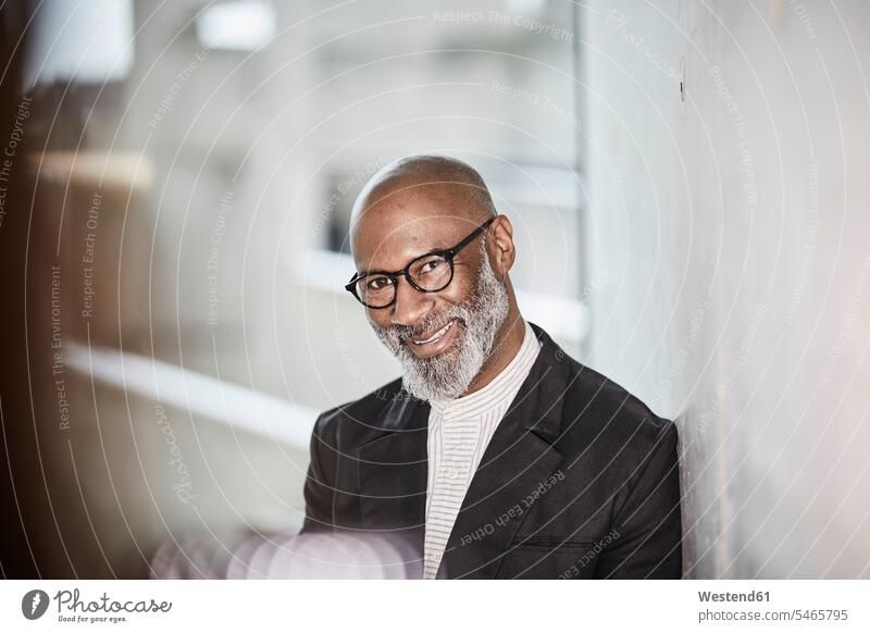 Portrait of smiling mature businessman with grey beard wearing glasses Businessman Business man Businessmen Business men portrait portraits males smile