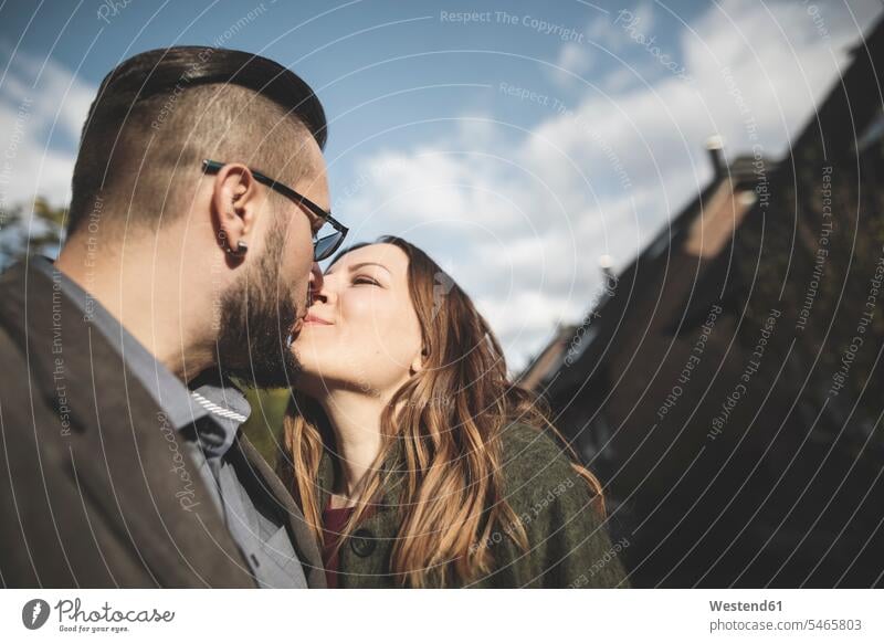 Couple kissing outdoors Affection Affectionate kisses couple twosomes partnership couples people persons human being humans human beings authenticity Candid