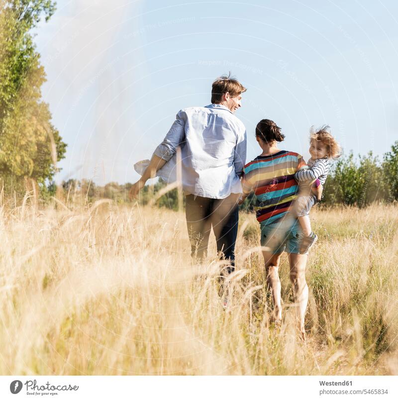 Happy family walking at the riverside on a beautiful summer day Meadow Meadows happiness happy going summer time summery summertime Plant Plants Security Secure