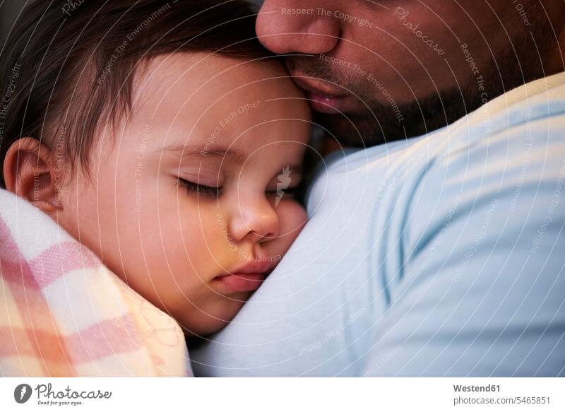 Close-up of father kissing sleeping baby girl pa fathers daddy dads papa daughter daughters infants nurselings babies asleep Affection Affectionate parents