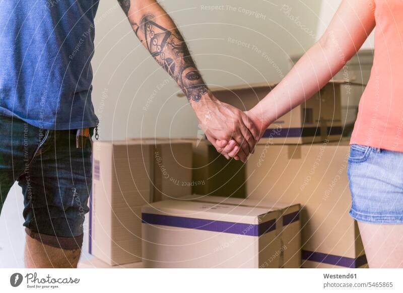 Couple holding hands at new home, partial view human hand human hands couple twosomes partnership couples people persons human being humans human beings