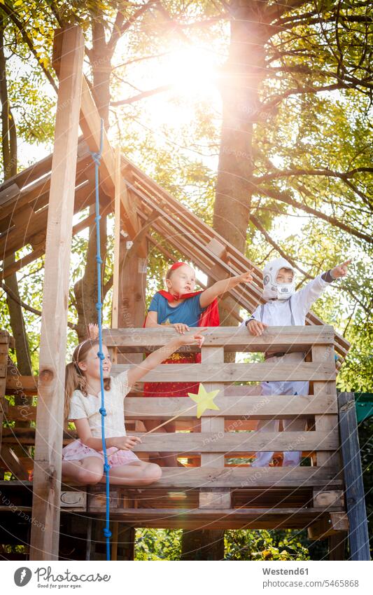 Three kids with superheroes costumes playing on their tree house human human being human beings humans person persons braver bravers spacemen astronauts ropes