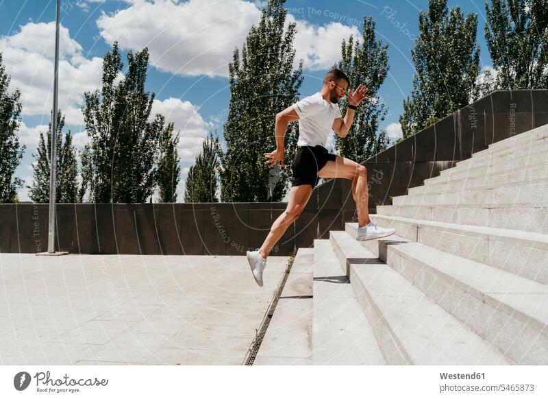 Male athlete running up stairs T- Shirt t-shirts tee-shirt colour colours White Colors sports fit athletes Sports Person Sportsman Sportsmen Sportspeople