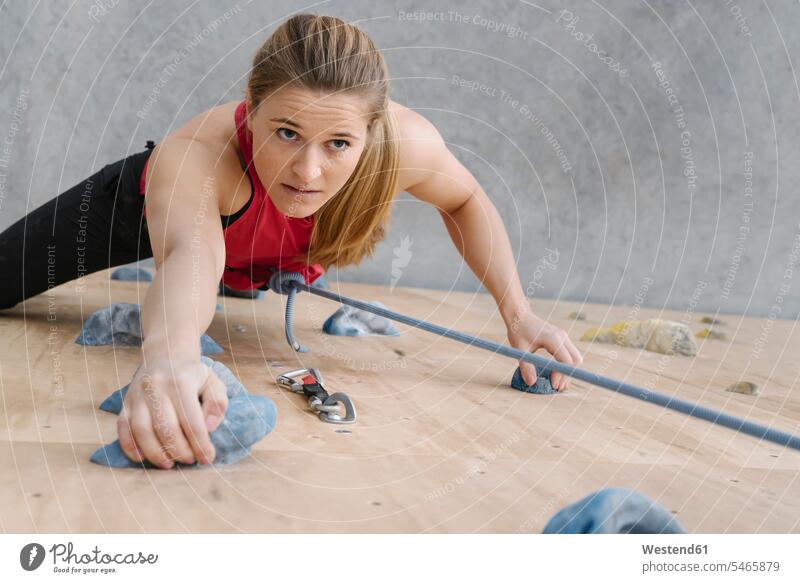 Woman climbing on the wall in climbing gym (value=0) portraits human human being human beings humans person persons 1 one person only only one person adult