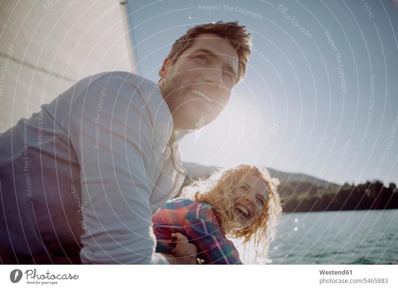 Happy couple on a sailing boat twosomes partnership couples sailboat Sail Boat Sailboats sailing boats happiness happy people persons human being humans