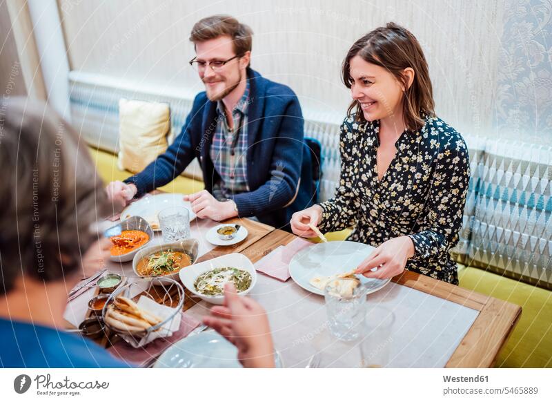 Friends dining in an Indian restaurant human human being human beings humans person persons caucasian appearance caucasian ethnicity european Group