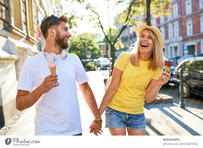 Happy young couple enjoying ice cream in the city touristic tourists hats T- Shirt t-shirts tee-shirt motor vehicles road vehicle road vehicles Auto automobile