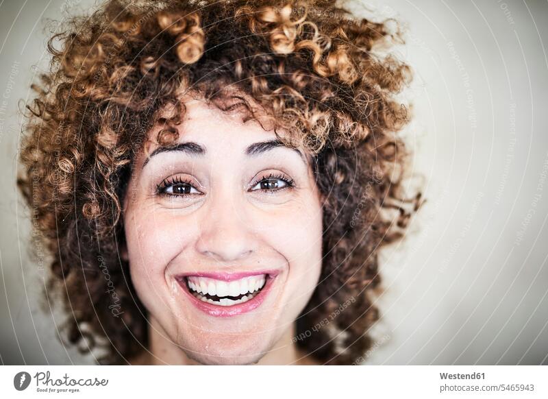 Portrait of sweating laughing woman with curly hair curls curled females women Laughter portrait portraits perspiration people persons human being humans
