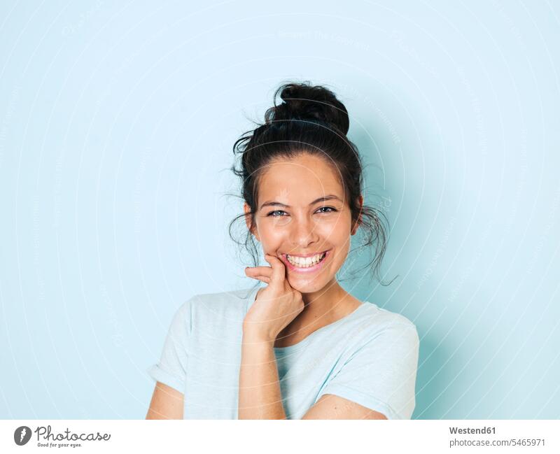 Portrait of young woman with black hair, light blue background caucasian caucasian ethnicity caucasian appearance european leisure free time leisure time