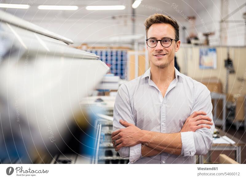 Portrait of smiling young businessman in factory portrait portraits factories smile confidence confident Businessman Business man Businessmen Business men