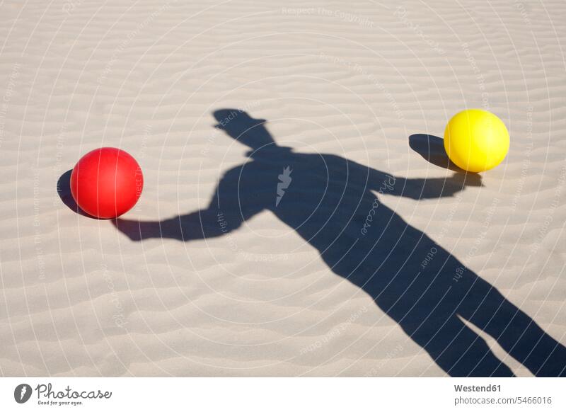 Shadow of man wearing a bowler hat and two balloons in sand shadow shadows Shades sandy men males hats Adults grown-ups grownups adult people persons