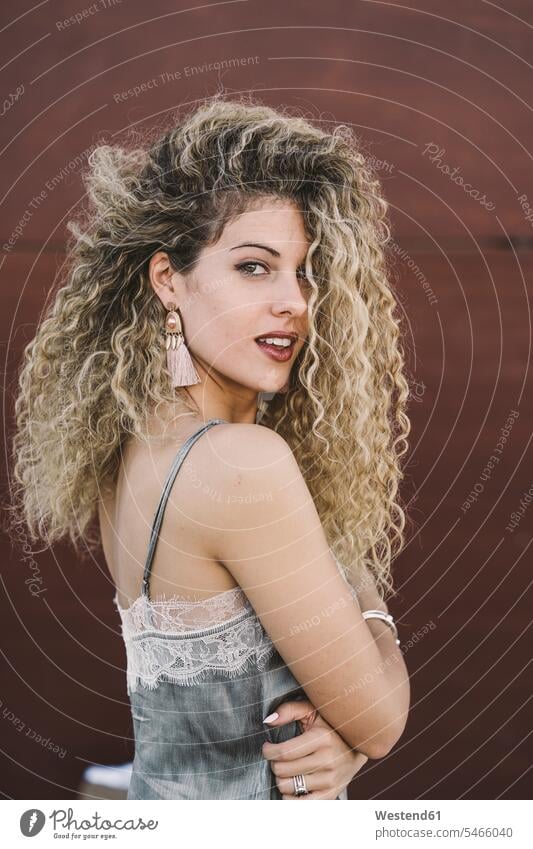 Portrait of fashionable young woman with dyed blond ringlets human human being human beings humans person persons caucasian appearance caucasian ethnicity