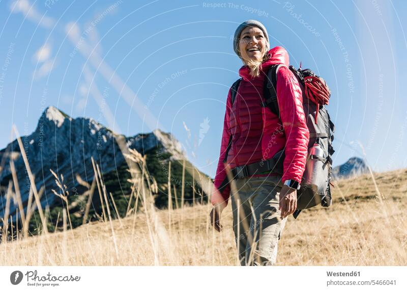 Austria, Tyrol, happy woman on a hiking trip in the mountains mountain range mountain ranges females women happiness hike hiking tour walking tour landscape