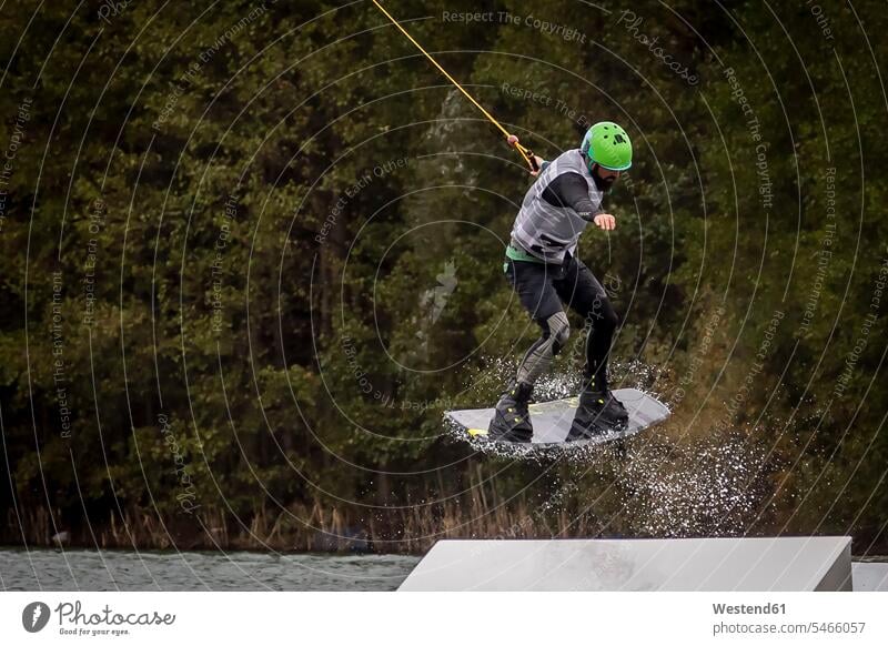 Man on wakeboard man men males Wakeboarder water ski water skis funsport jumping Leaping Adults grown-ups grownups adult people persons human being humans