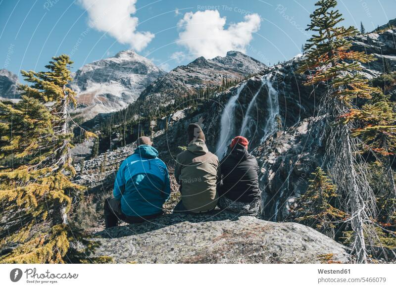Canada, British Columbia, Glacier National Park, three hikers resting at Sir Donald Trail man men males wanderers break Adults grown-ups grownups adult people