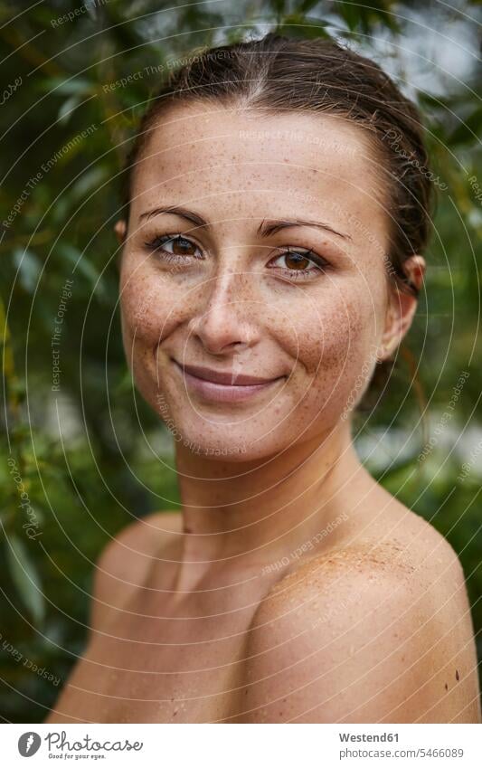 Portrait of freckled young woman in nature freckles natural world females women portrait portraits people persons human being humans human beings Adults