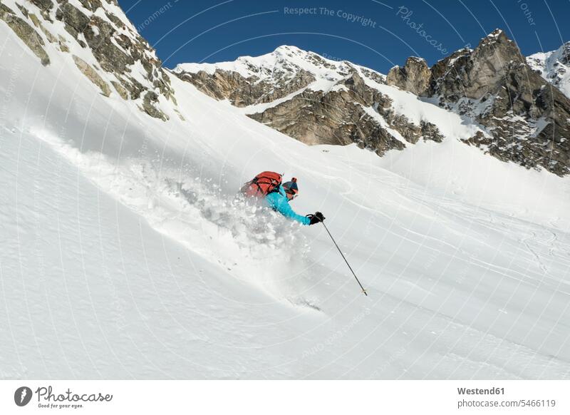 Switzerland, Grand Saint Bernard Pass, Pain de Sucre, Mont Fourchon, woman on a ski tour in the mountains riding downhill Downhill Skiing females women