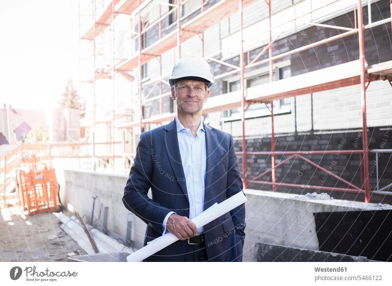Portrait of confident architect wearing hard hat on construction site architects standing portrait portraits confidence hard hats hardhats hard-hat occupation