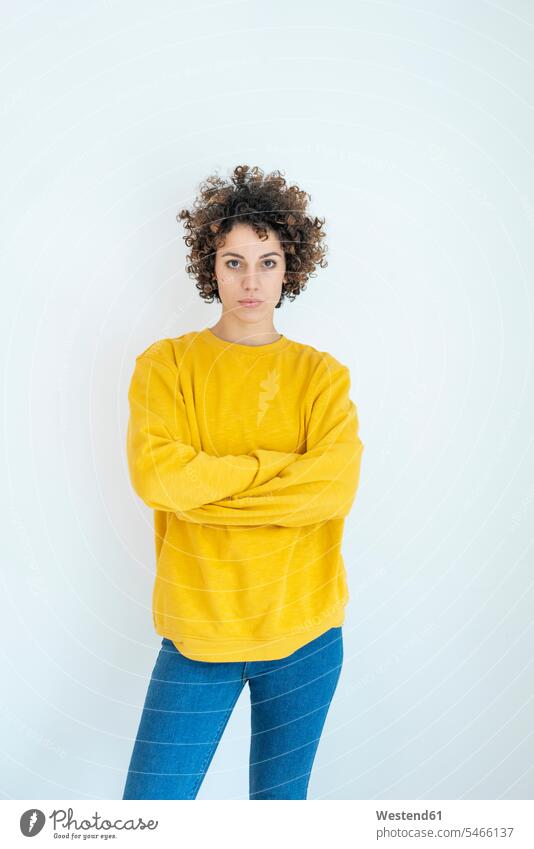 Portrait of confident woman wearing yellow sweater pullover jumper Sweaters standing females women Self-confidence self-confident poised Self-Assured