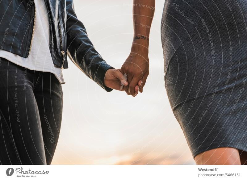 Close-up of lesbian couple holding hands outdoors twosomes partnership couples Affection Affectionate human hand human hands people persons human being humans