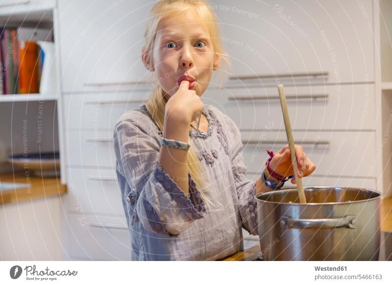 Portrait of girl cooking jam at home finger fingers Joy enjoyment pleasure Pleasant delight tasty savoury yummy Mouth-watering appetising savory Mouthwatering