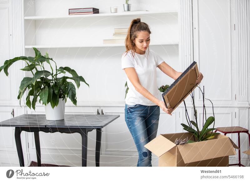 Woman packing cardboard boxes apartment flats apartments woman females women home at home moving house move Moving Home Cardboard Carton carton Cardboards