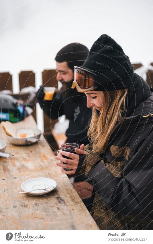 Couple in skiwear having a hot drink at mountain lodge Hot Drink Hot Drinks heat Hot Temperature couple twosomes partnership couples people persons human being