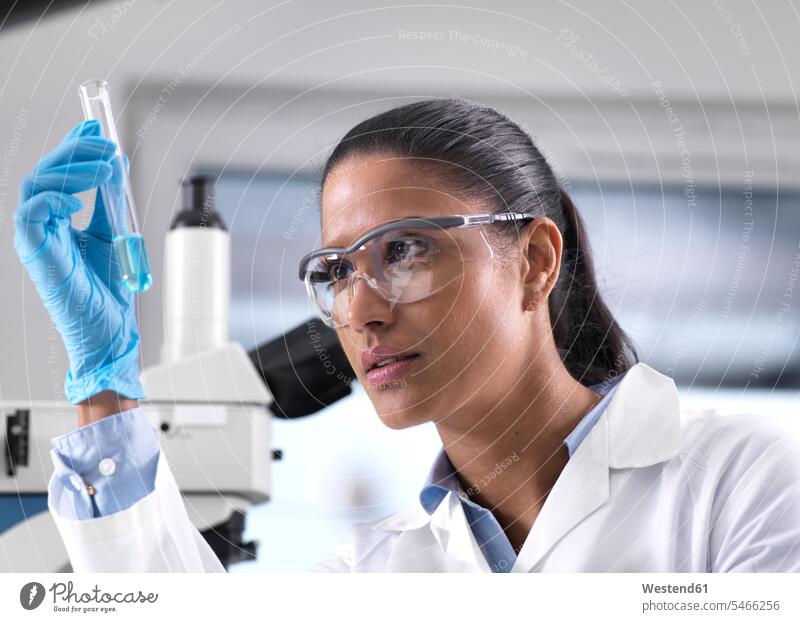 Biotechnology Research, female scientist mixing a chemical formula experiment experimenting female scientists female researcher research scientist analysis