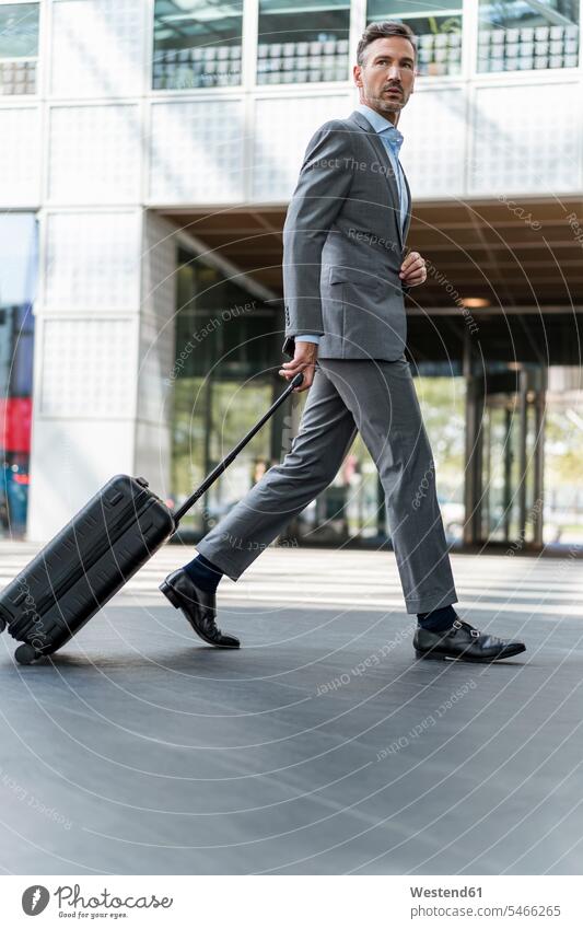Businessman with baggage on the go Occupation Work job jobs profession professional occupation business life business world business person businesspeople
