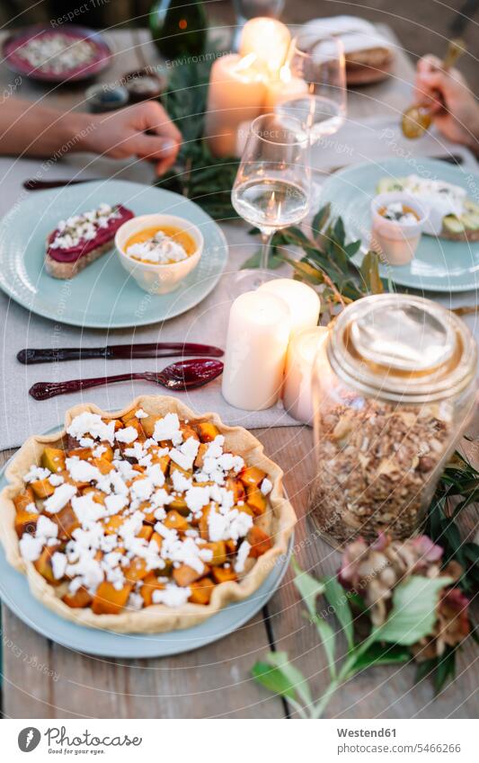 Close-up of couple having a romantic candlelight meal outdoors Meals twosomes partnership couples lyrical Romance candle light Food foods food and drink
