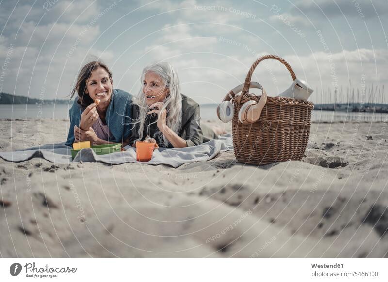 Mother and daughter having a picnic on the beach human human being human beings humans person persons caucasian appearance caucasian ethnicity european 2