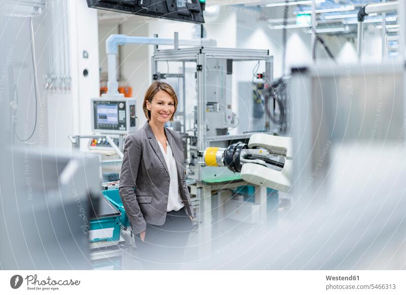 Portrait of a smiling businesswoman in a modern factory human human being human beings humans person persons caucasian appearance caucasian ethnicity european 1
