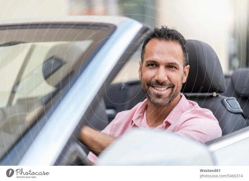 Portrait of smiling man driving convertible caucasian caucasian ethnicity caucasian appearance european wealth affluence prosperity Affluent car automobile Auto