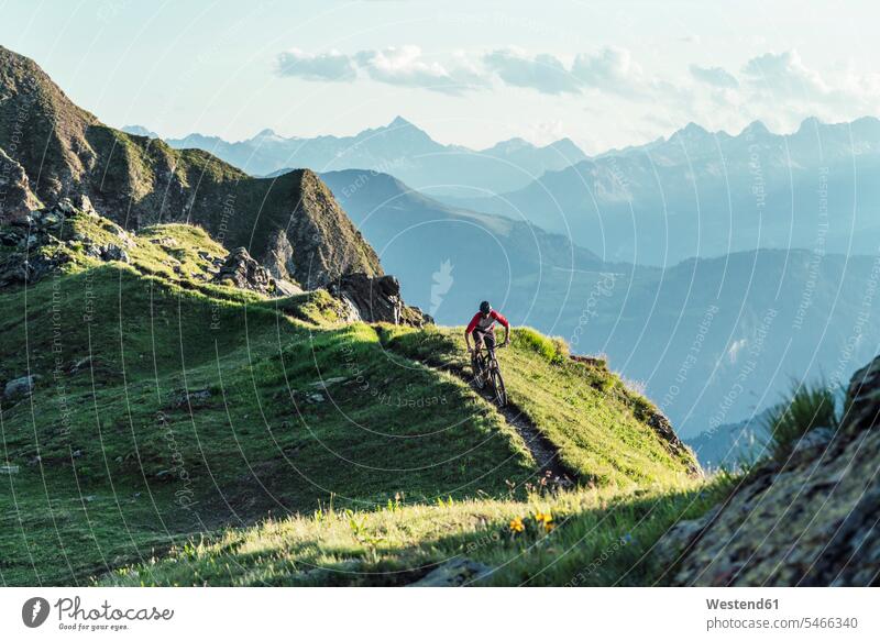 Mountainbiker on a way on a ridge, Grisons, Switzerland bikes bicycles bike - bicycle Cycle Cycle - Vehicle exercise practising train training drive sports