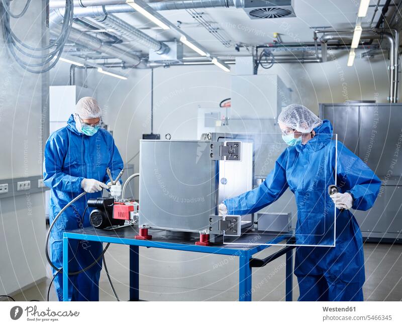 Chemists working in industrial laboratory clean room At Work Protective Suit chemist Chemical Laboratory sterile clothing hygiene natural scientist science