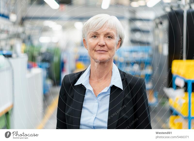 Portrait of confident senior businesswoman in a factory factories confidence businesswomen business woman business women portrait portraits business people