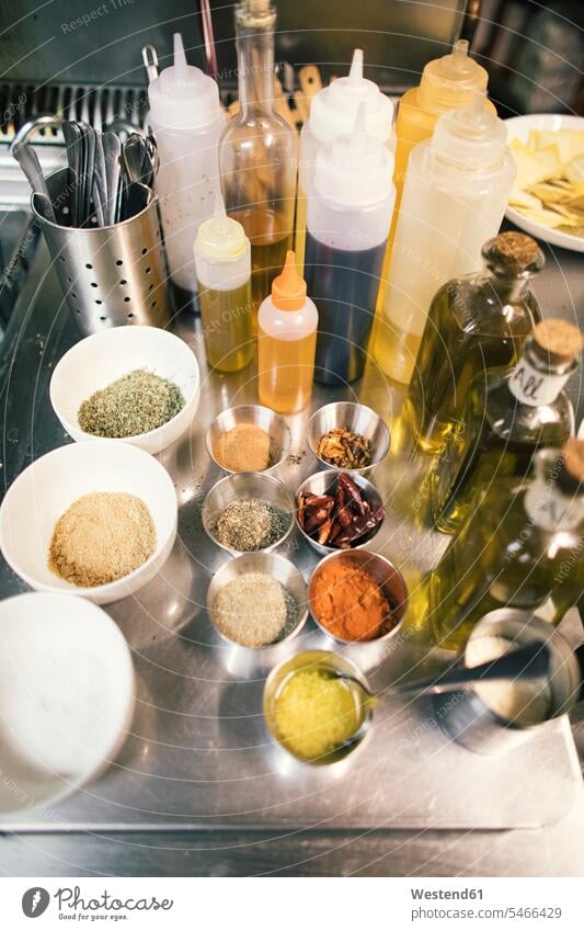 Close-up of spices and oil bottles in restaurant kitchen Bottles Glass Bottles Bowls cook Diverse diversification diversity varied traditional Traditions