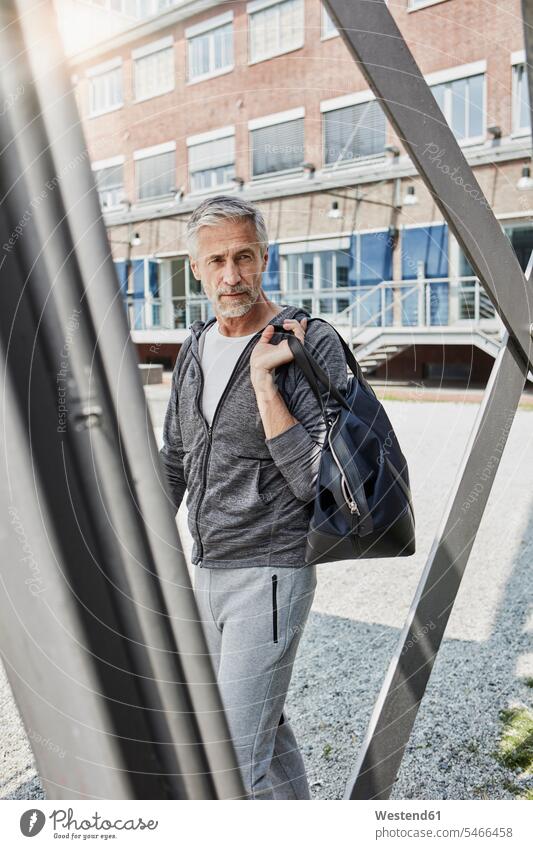 Portrait of mature man with sports bag on the way to gym gyms Health Club Gym Bag men males portrait portraits fitness Adults grown-ups grownups adult people